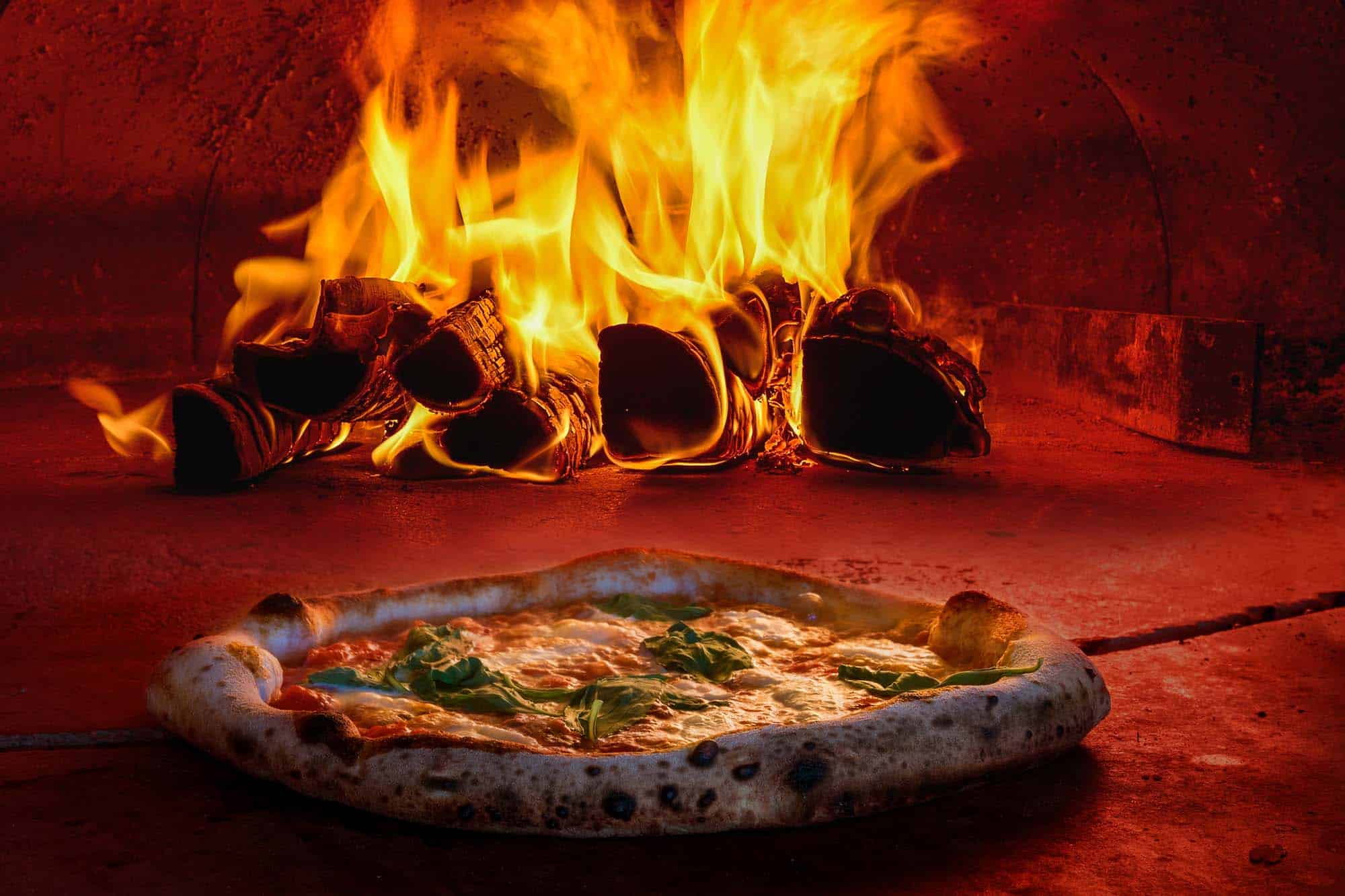 Traditional way baked wood fired oven Italian pizza bakery pizzeria